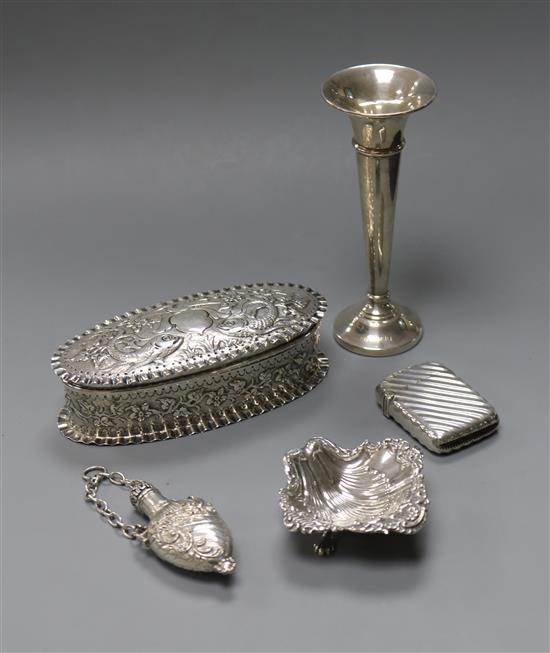 A late Victorian repousse silver trinket box, a silver spill vase, silver salt, silver vesta case and a scent flask.